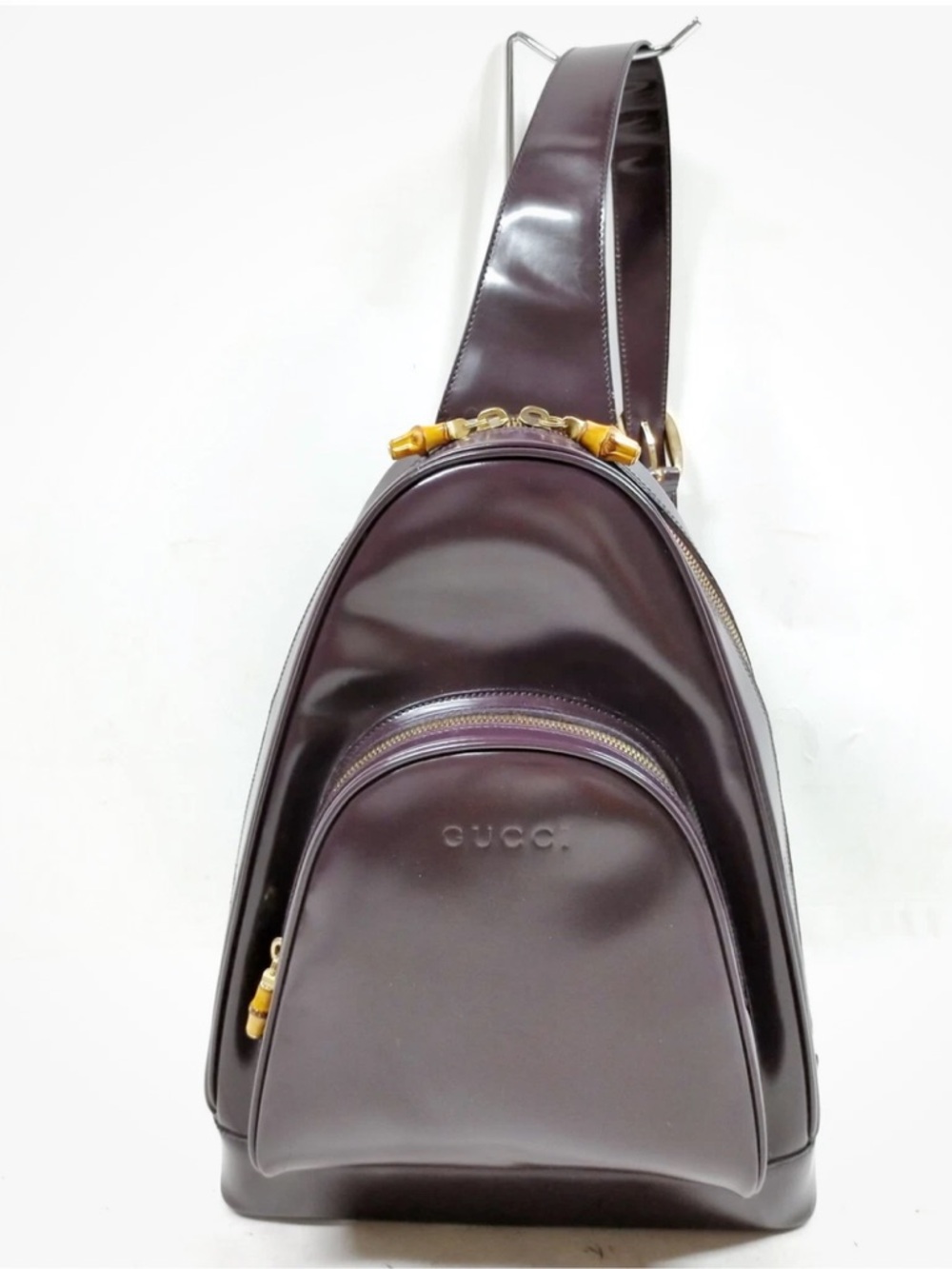 Gucci Patent Leather Sling Backpack in Deep Plum with Gold Bamboo Accents